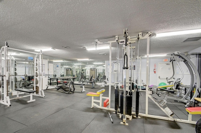 gym featuring a textured ceiling