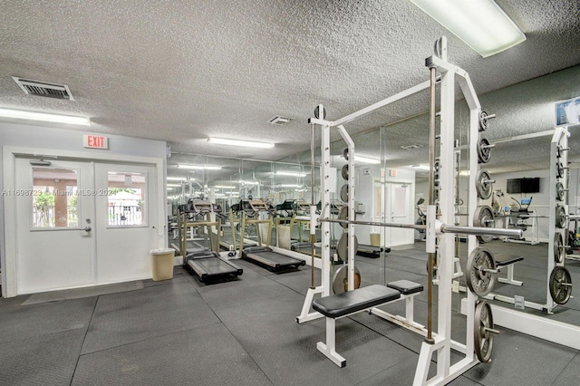 exercise room with a textured ceiling