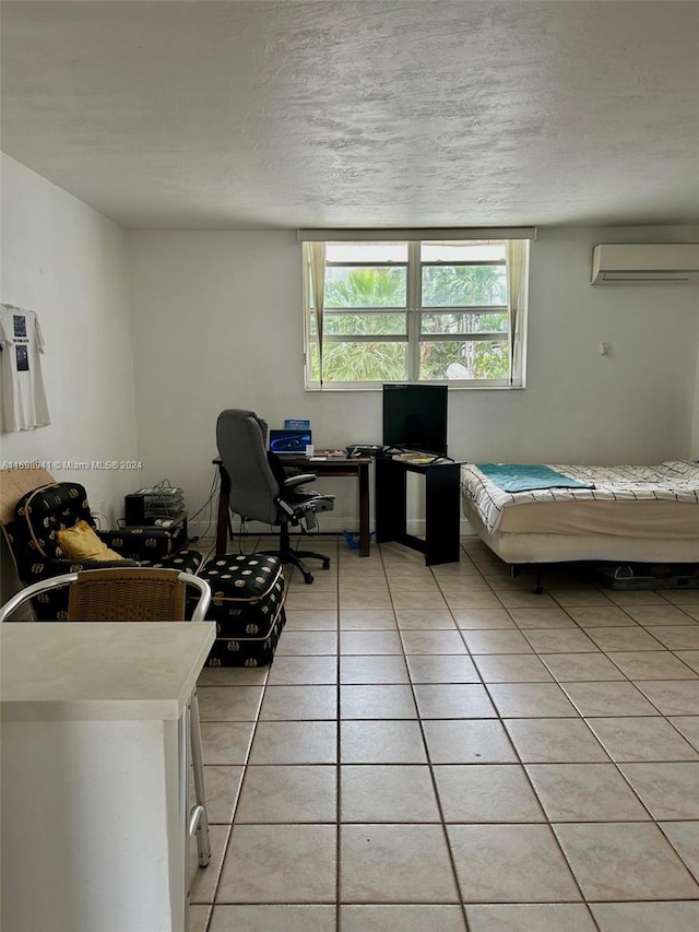 bedroom featuring an AC wall unit, tile patterned floors, a textured ceiling, and pool table