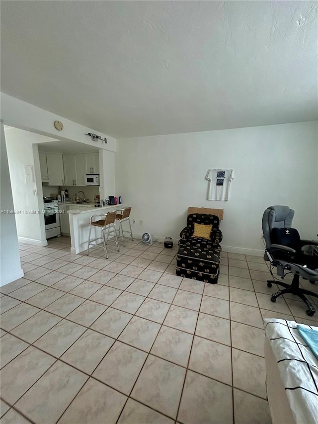 unfurnished room with light tile patterned floors and sink