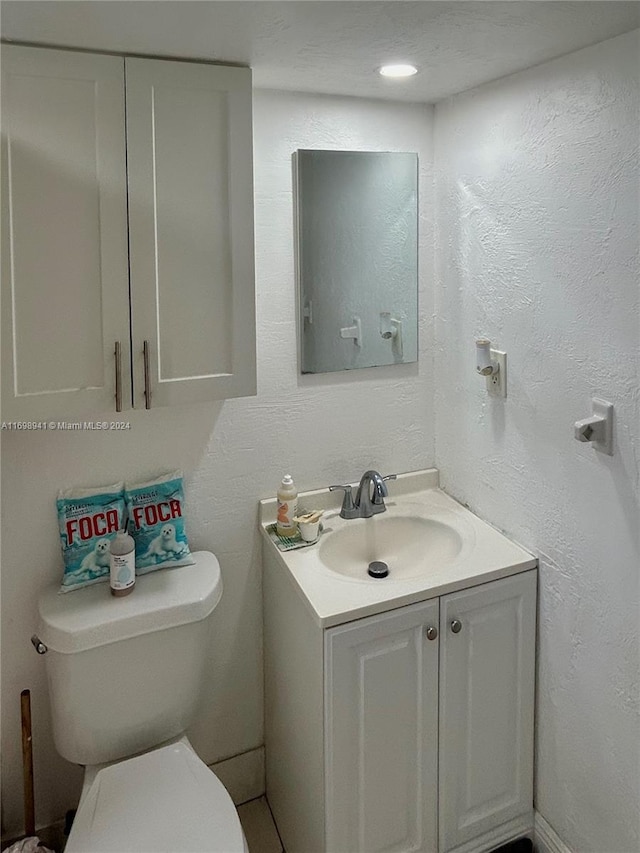 bathroom with vanity, a textured ceiling, and toilet