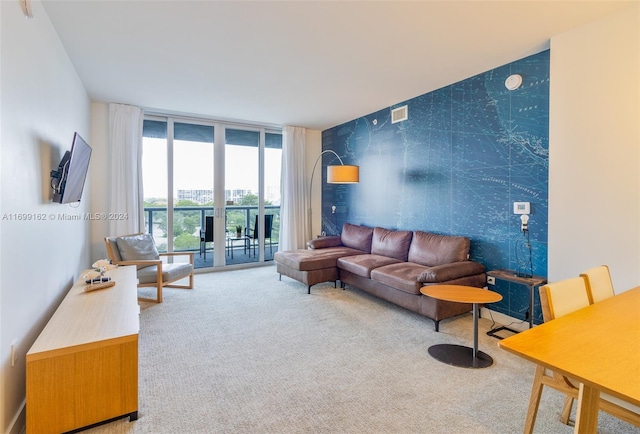 living room with carpet flooring and a wall of windows