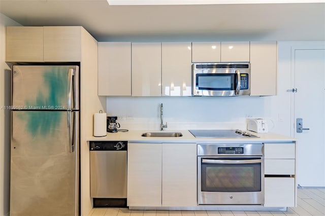 kitchen with white cabinets, sink, and appliances with stainless steel finishes