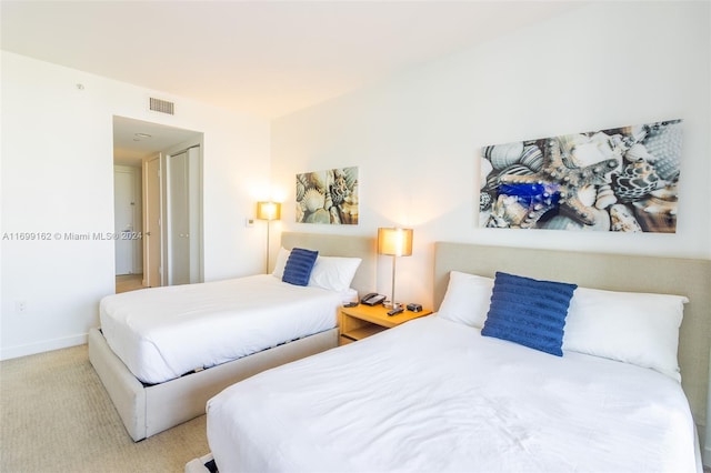 bedroom featuring light colored carpet