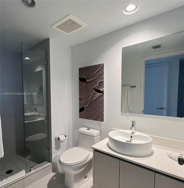 bathroom with walk in shower, tile patterned floors, vanity, and toilet