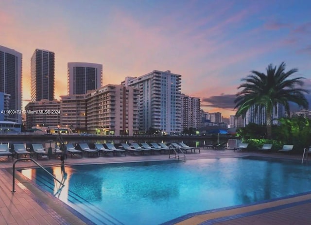 view of pool at dusk