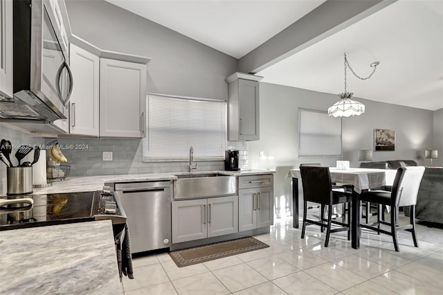 kitchen featuring gray cabinetry, sink, hanging light fixtures, stainless steel appliances, and light tile patterned floors