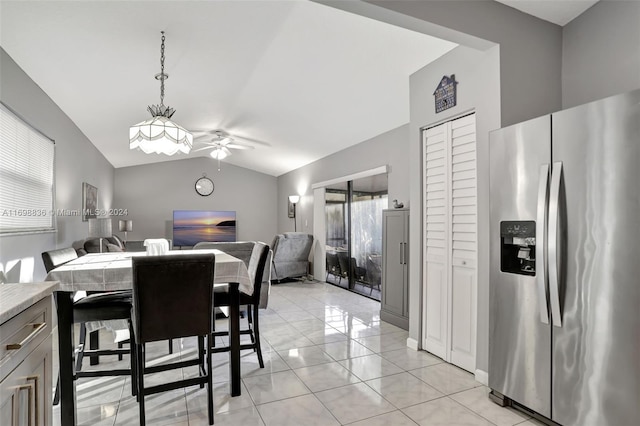 dining space featuring a wealth of natural light, vaulted ceiling, ceiling fan, and light tile patterned flooring