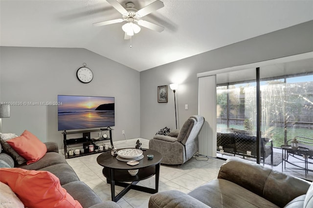 living room with ceiling fan, lofted ceiling, and light tile patterned floors