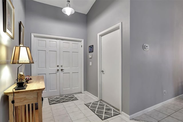 entryway with light tile patterned flooring