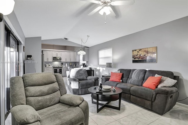 living room with ceiling fan and vaulted ceiling