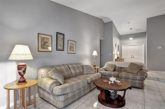 tiled living room featuring high vaulted ceiling