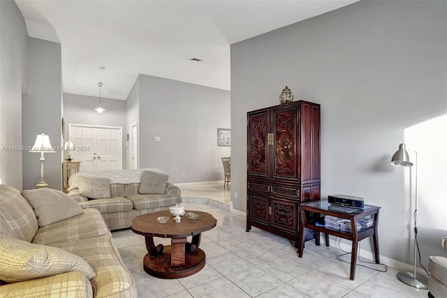 tiled living room featuring high vaulted ceiling