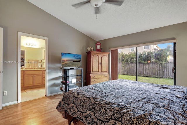 bedroom featuring ceiling fan, light hardwood / wood-style flooring, high vaulted ceiling, ensuite bathroom, and access to outside