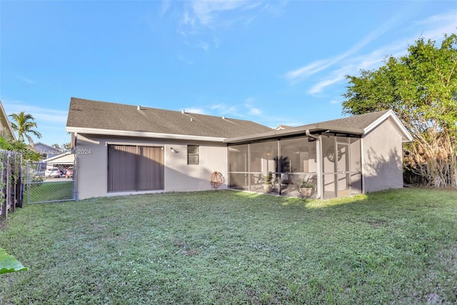 rear view of property with a lawn and a sunroom