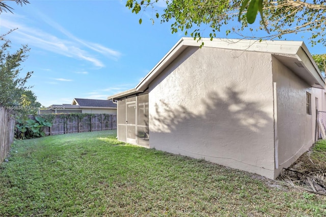 view of side of home featuring a lawn