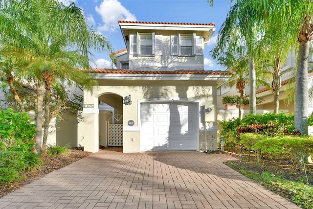 mediterranean / spanish-style home with a garage