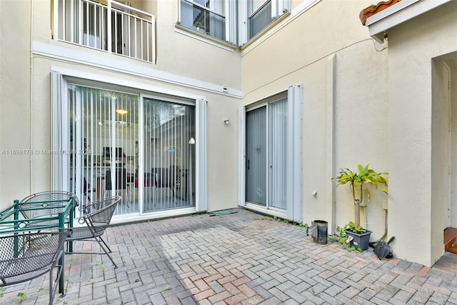 entrance to property featuring a patio area