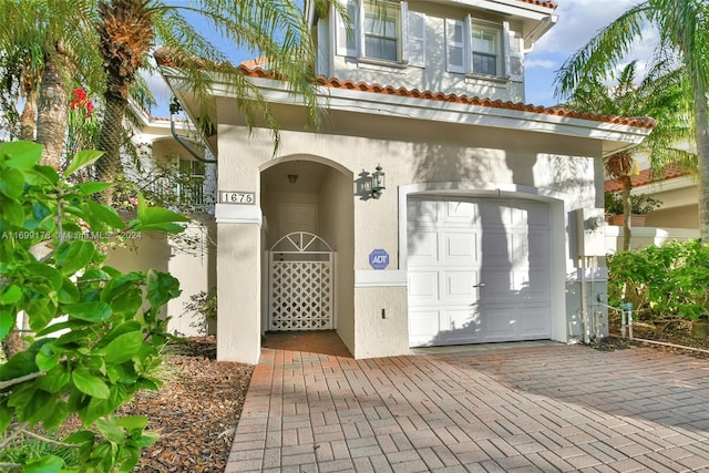 doorway to property with a garage