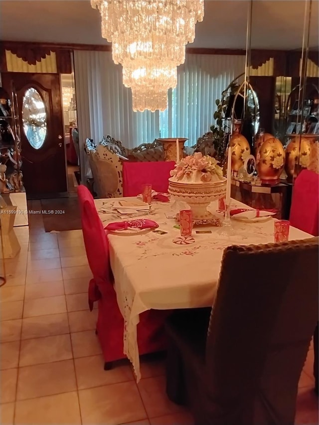 dining space featuring a notable chandelier and light tile patterned floors