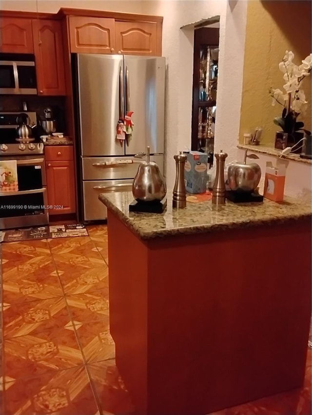 kitchen with light stone counters and stainless steel appliances