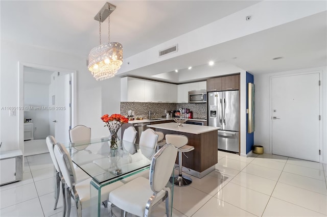 tiled dining area featuring sink