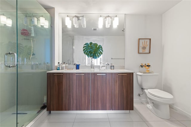 bathroom with tile patterned floors, vanity, toilet, and an enclosed shower