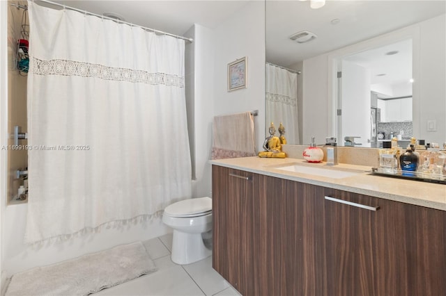 full bathroom featuring tile patterned flooring, shower / bath combo with shower curtain, toilet, tasteful backsplash, and vanity