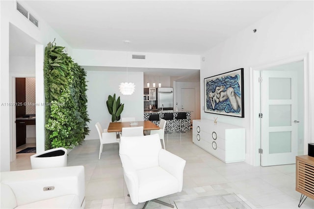 living room featuring light tile patterned floors and sink