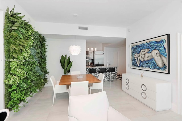 tiled dining area featuring sink