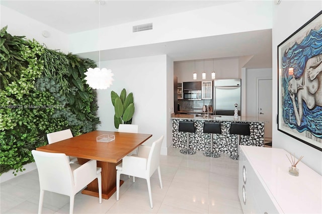 tiled dining space featuring sink