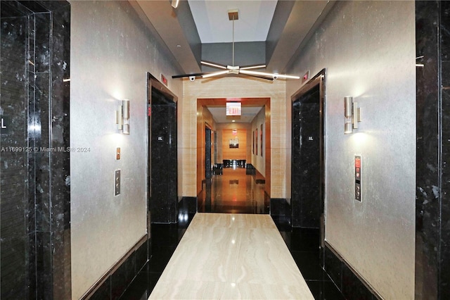 hallway featuring dark tile patterned flooring