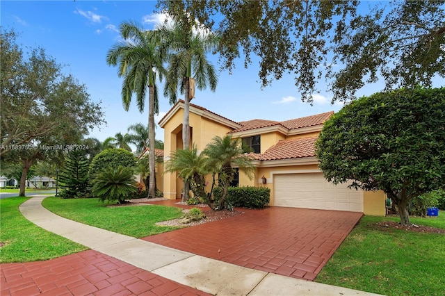 mediterranean / spanish home featuring a front yard