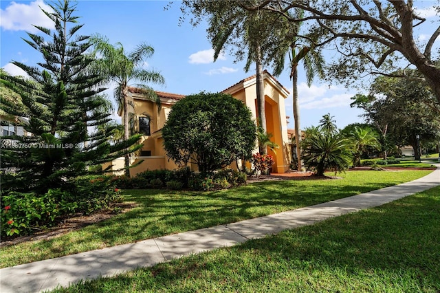 view of side of home with a lawn