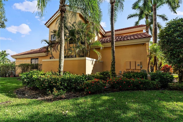 view of home's exterior with a lawn