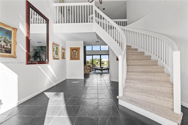 foyer entrance featuring a towering ceiling