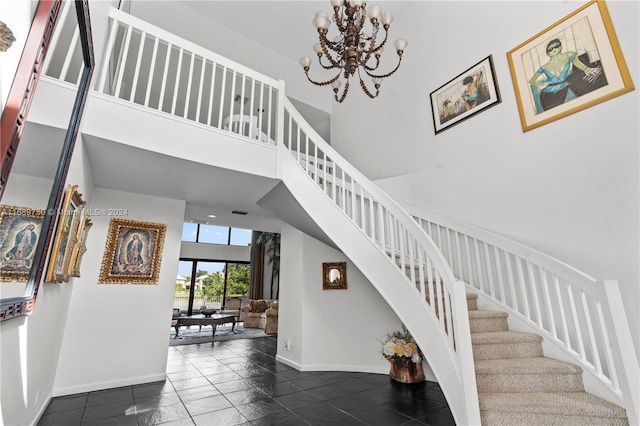 stairs featuring a towering ceiling and a chandelier