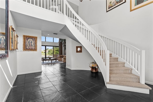 staircase featuring a high ceiling