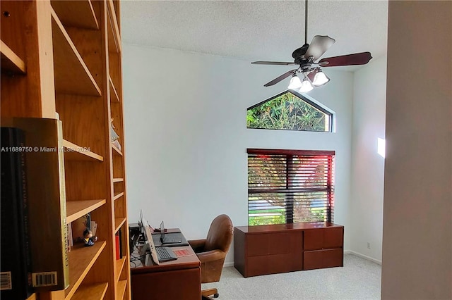 carpeted home office with a textured ceiling, ceiling fan, and a healthy amount of sunlight