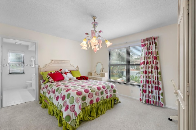 carpeted bedroom with a textured ceiling, an inviting chandelier, and ensuite bath