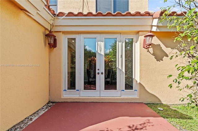 view of exterior entry featuring french doors