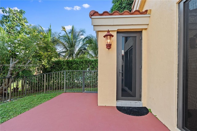 view of exterior entry featuring a patio area