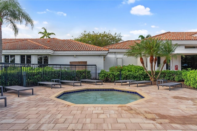 view of swimming pool with a hot tub and a patio area