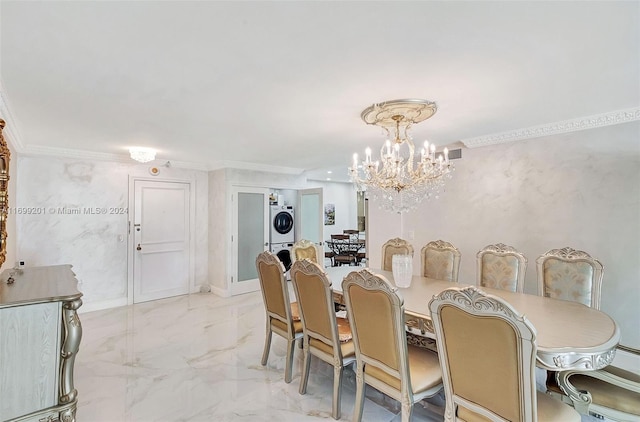 dining space featuring crown molding, stacked washer and dryer, and an inviting chandelier