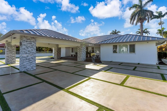 10 SW 124th Ave, Miami, FL 33184 - rear view of property featuring a standing seam roof, metal roof, and stucco siding