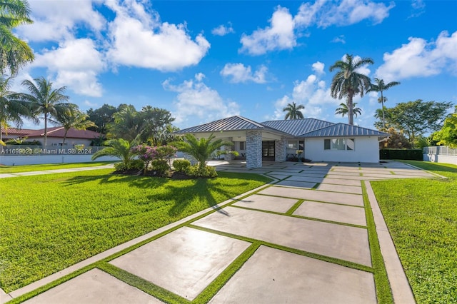 10 SW 124th Ave, Miami, FL 33184 - view of front facade with a standing seam roof, a front yard, and metal roof