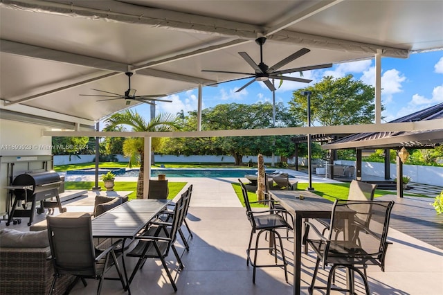 view of patio featuring ceiling fan and a grill