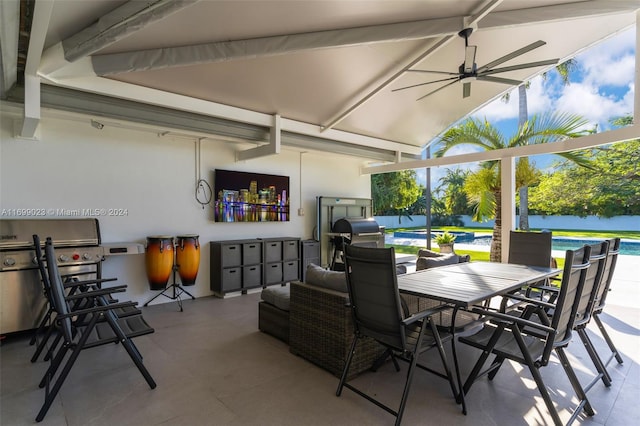 view of patio / terrace with grilling area, ceiling fan, and a pool