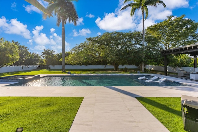 view of swimming pool with a patio, a yard, and a hot tub