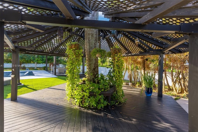 wooden terrace featuring a pergola, a yard, and a patio